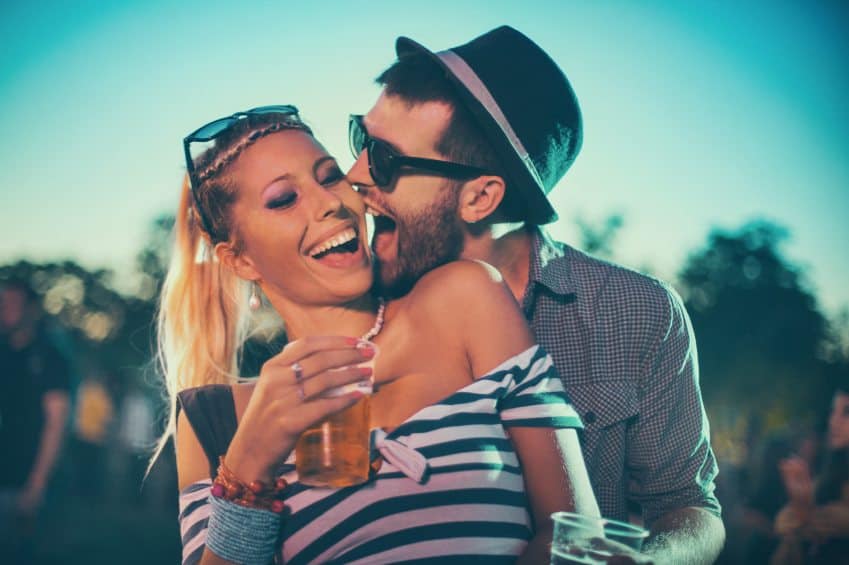 Couple laughing and drinking