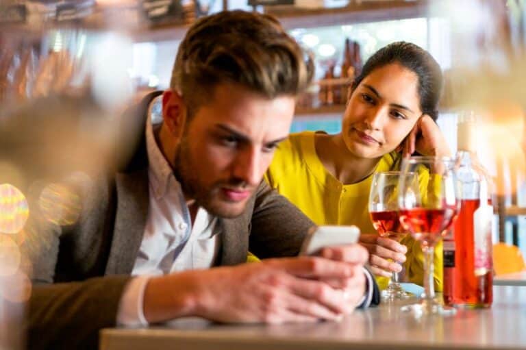 Couple unhappy at a bar.