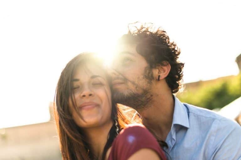 happy couple embracing sunset