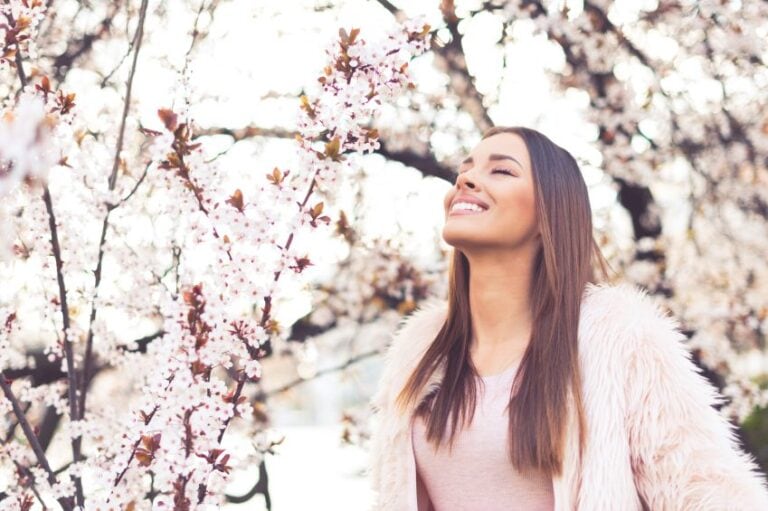 woman happy cherry blossoms