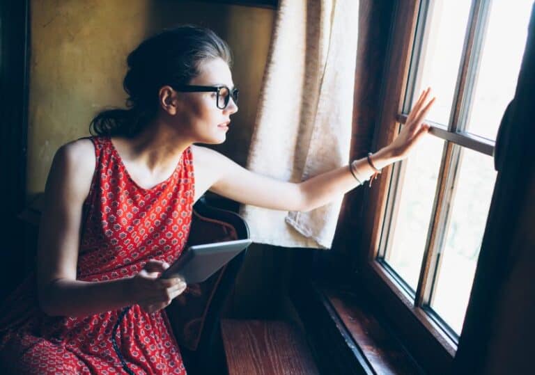Hipster woman looking out window