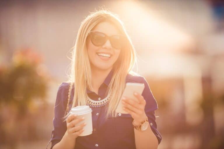Blonde woman laughing at text