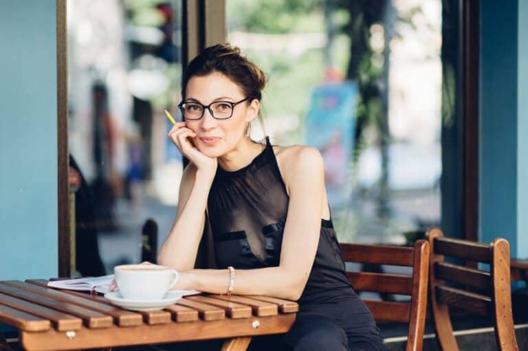 Attractive girl with a notepad in the cafe