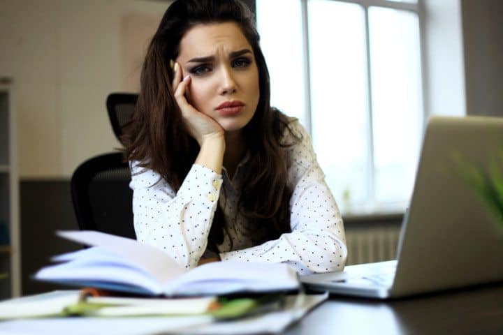 Tired woman taking notes