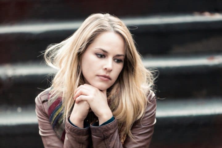 Sad looking woman on steps