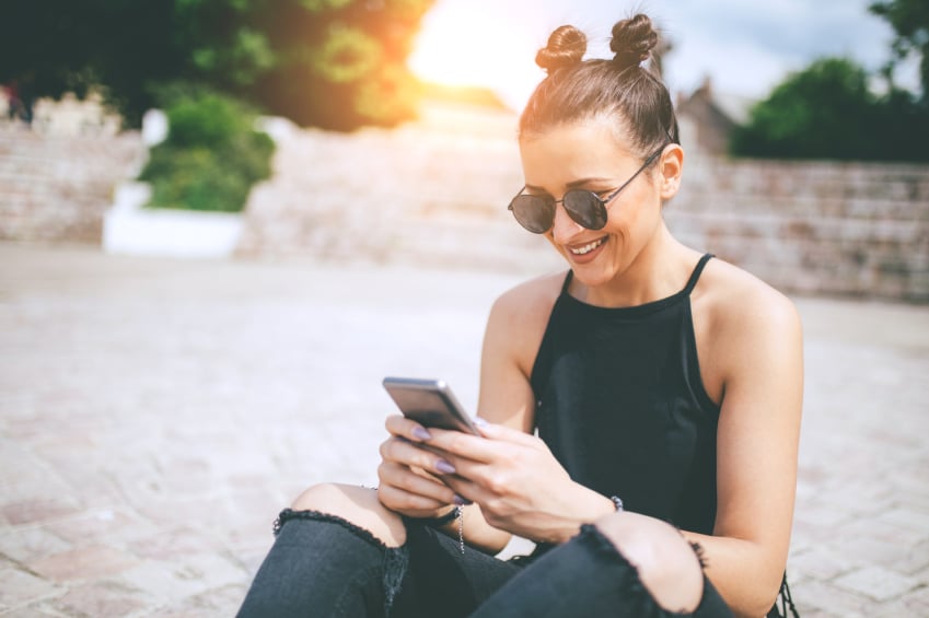 Hipster female with smartphone summer