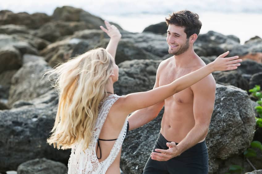 Young couple reaching out to embrace one another