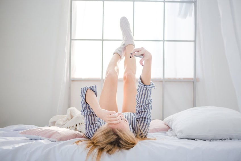 woman laying on her bed