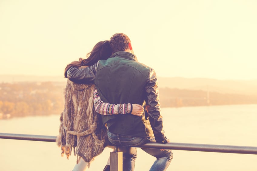 Couple sitting on a railing