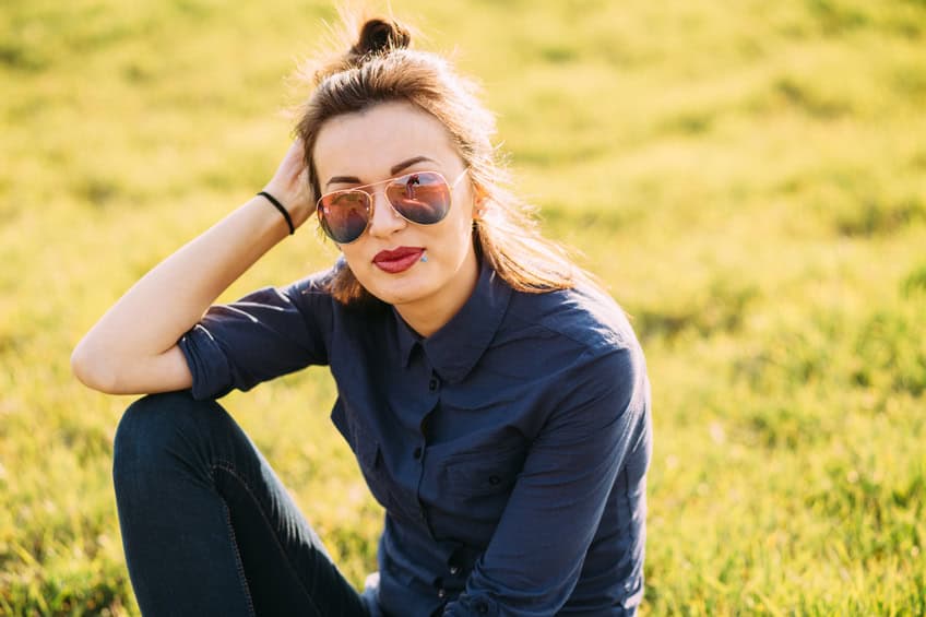 Beautiful woman sitting on the grass.