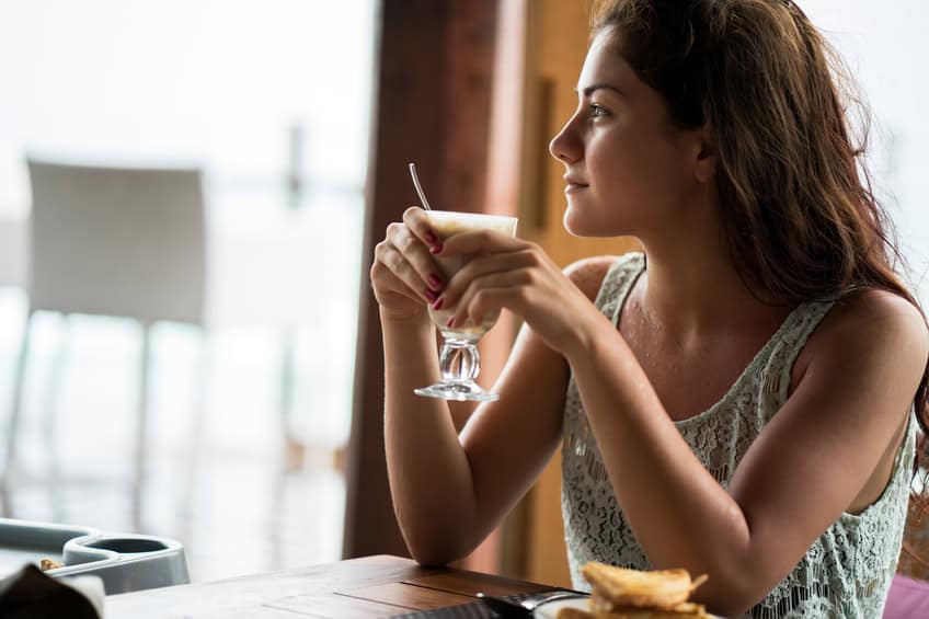 Young beautiful woman relaxing in a cafe.
