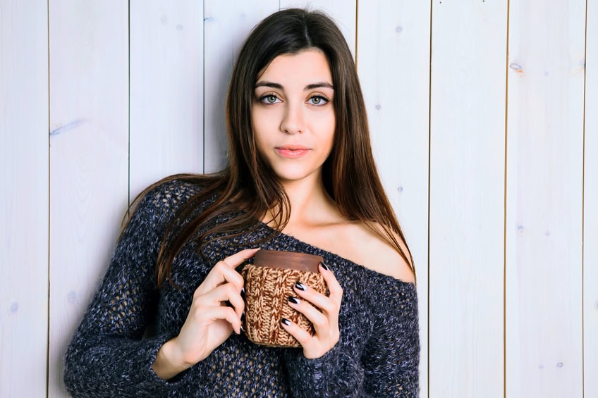 The girl with a wooden cup in his hands