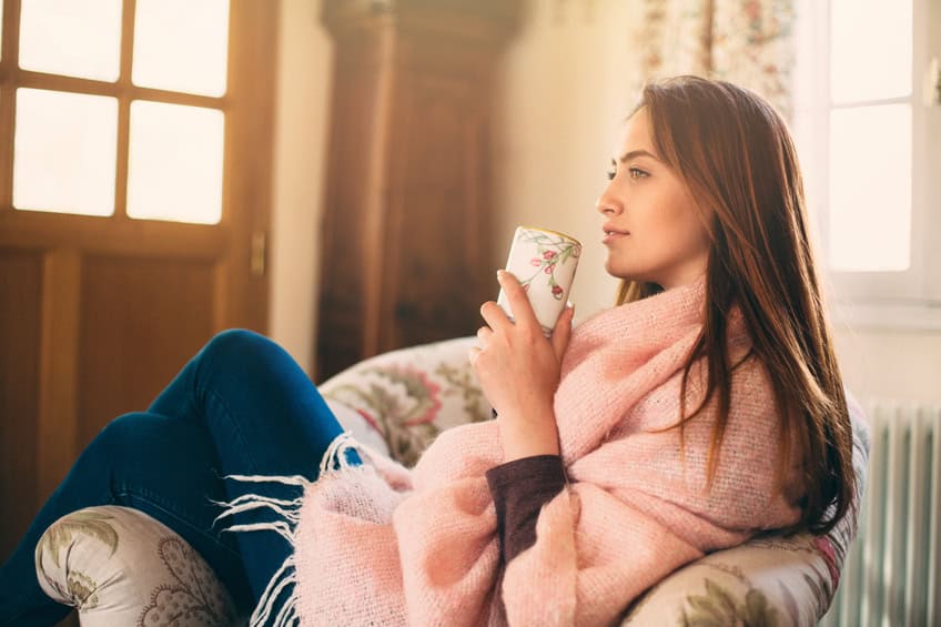 Beautiful young woman holding a cup of coffee.