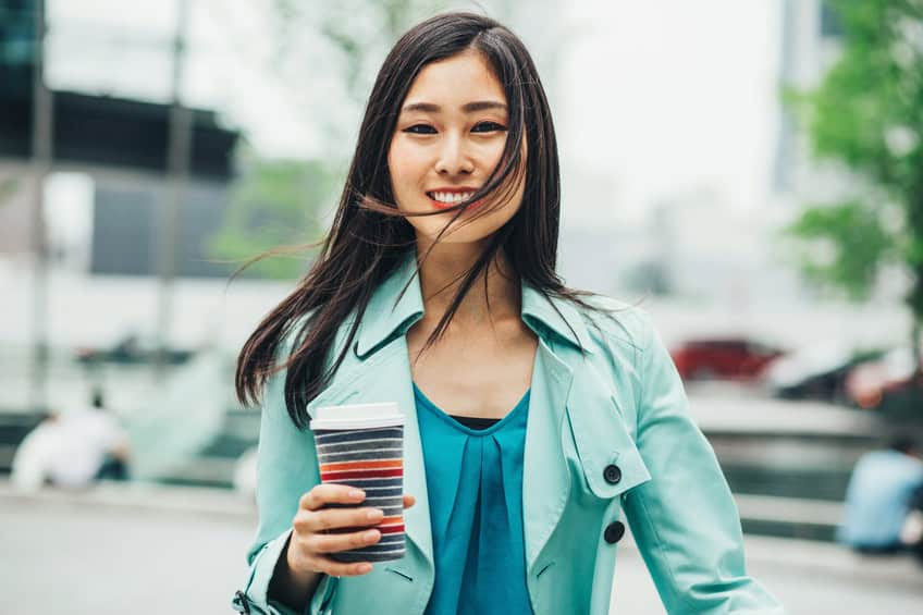 smiling woman coffee outdoors