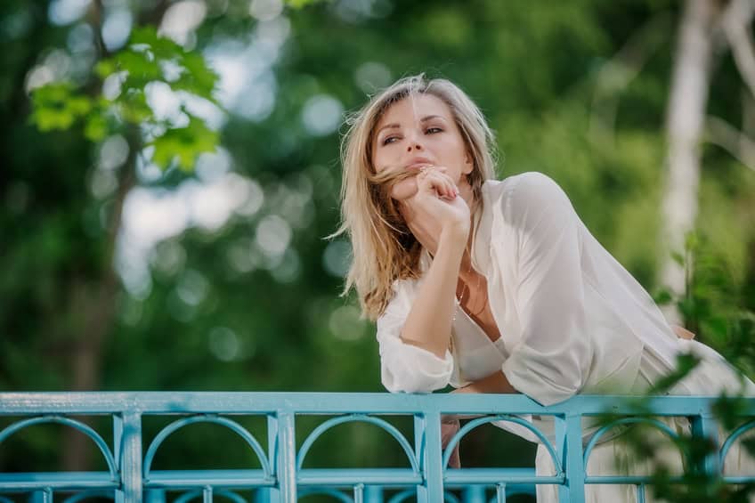 Blonde woman looking over bridge