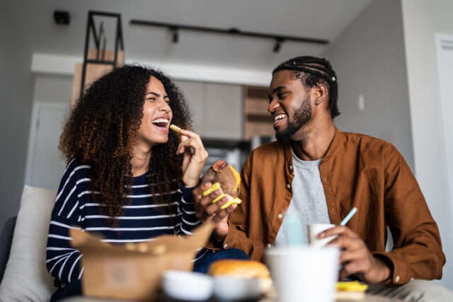 happy couple eating fast food together