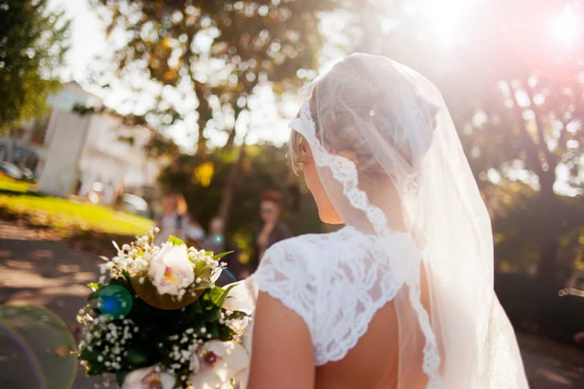 Beautiful bride holding flower bouquet