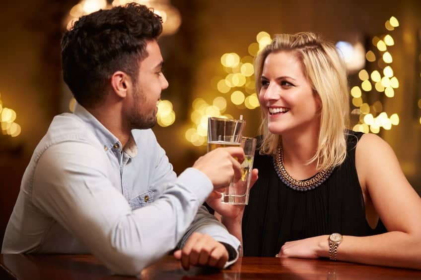 Couple Enjoying Evening Drinks In Bar