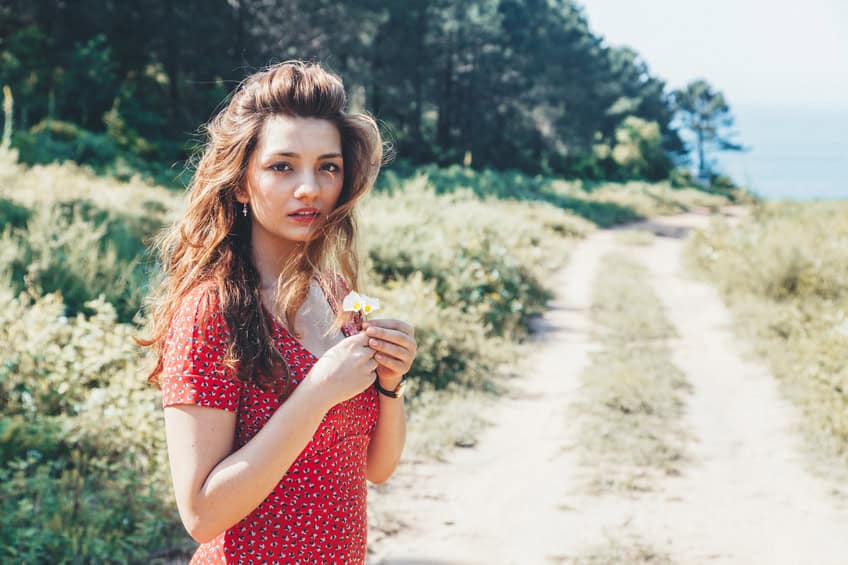 beautiful young woman sun dirt road