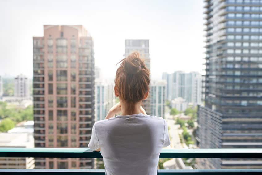 woman alone balcony city view