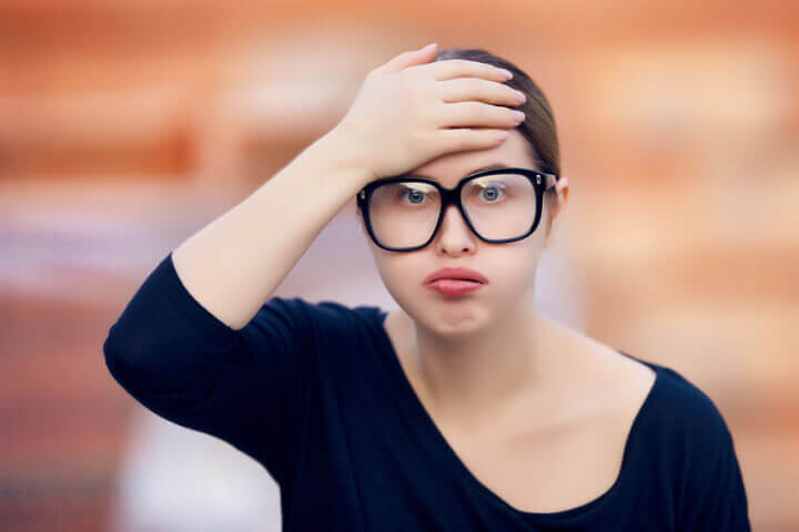 Young woman with glasses confused