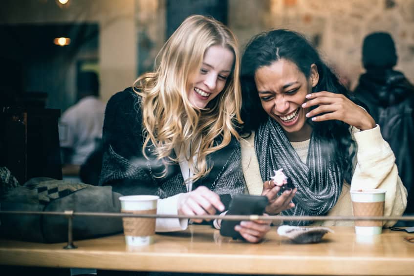 friends laughing coffee shop
