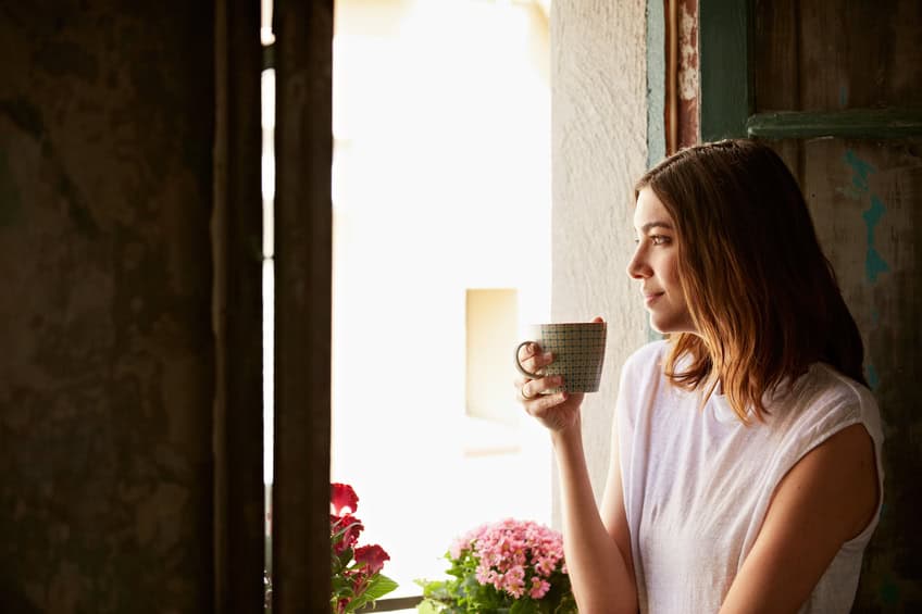 Young brunette thinking window
