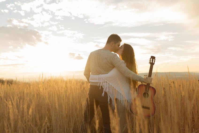Couple kissing in a field