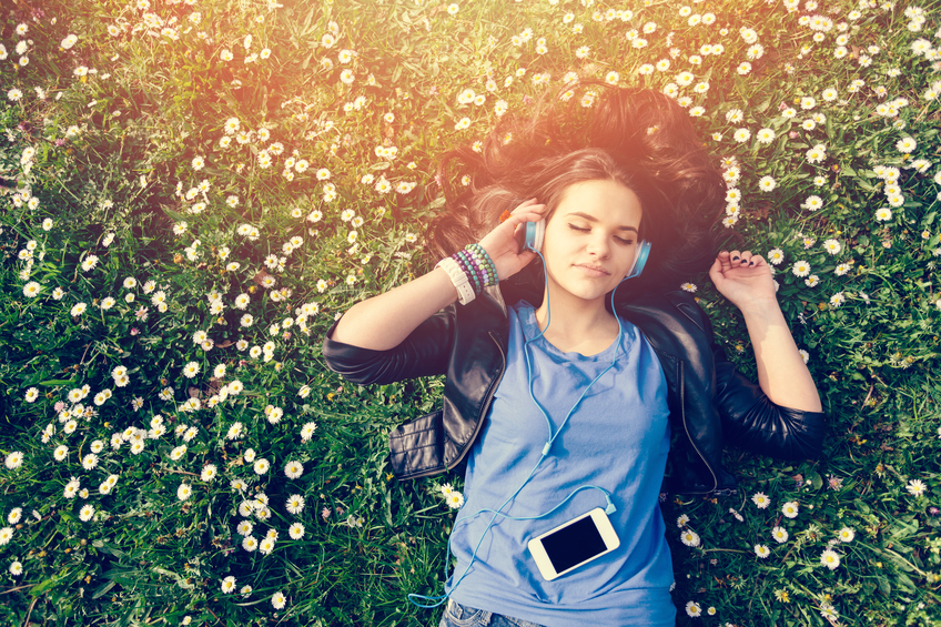 woman grass headphones summer