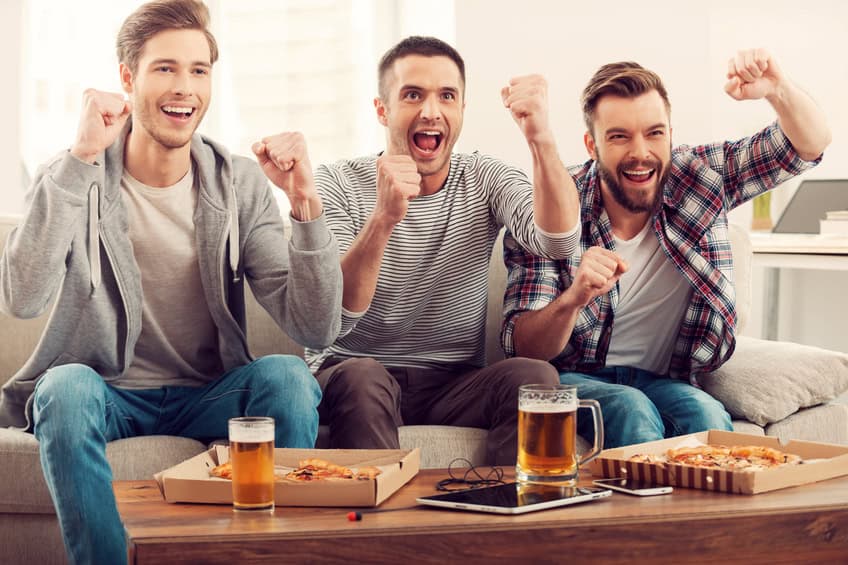 Three men watching football.