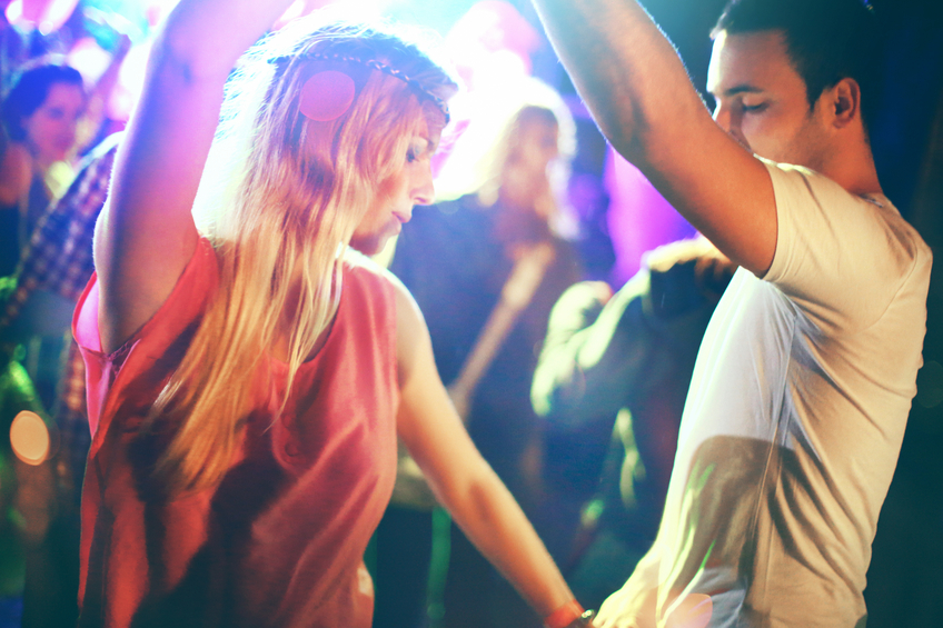 Two people dancing at concert.