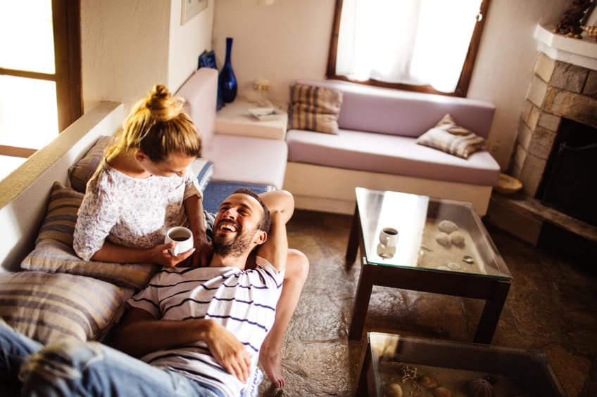 couple happy couch home comfort
