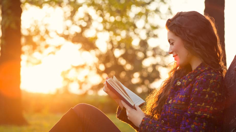 woman reading sunset autumn trees