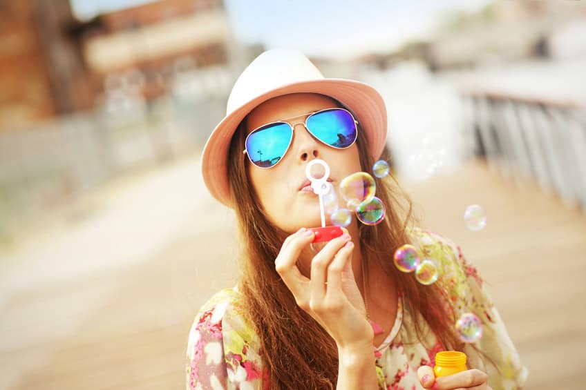 woman blowing bubbles summer outdoors