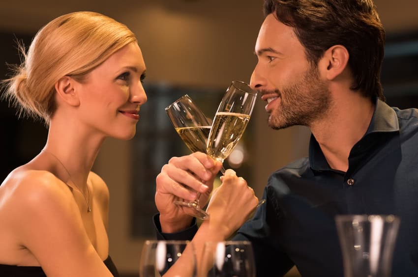 Couple making a toast with champagne.