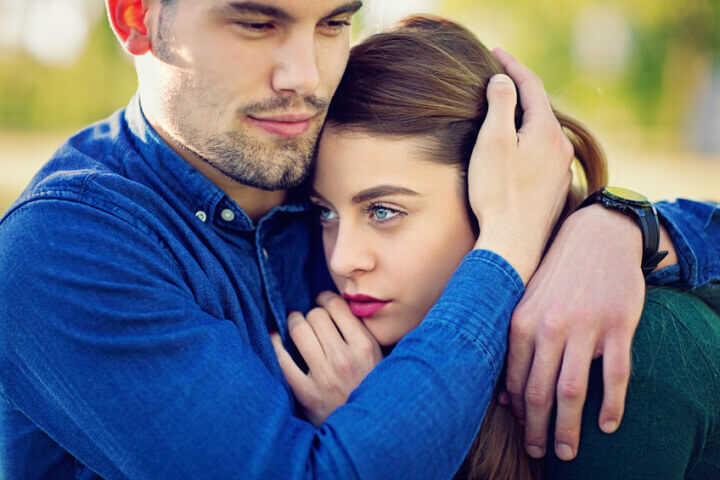 Young couple is standing in the park.
