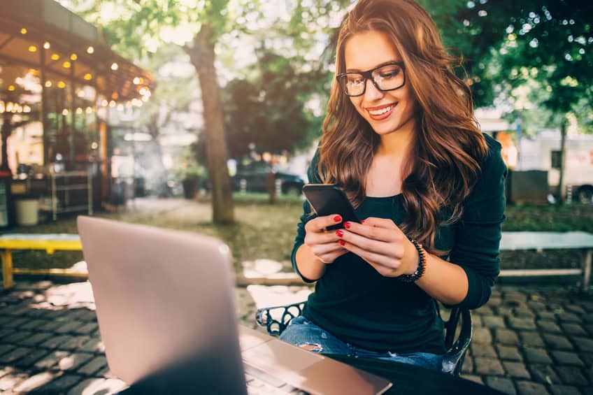 woman phone laptop technology
