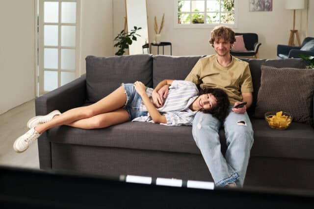 couple cuddling on couch