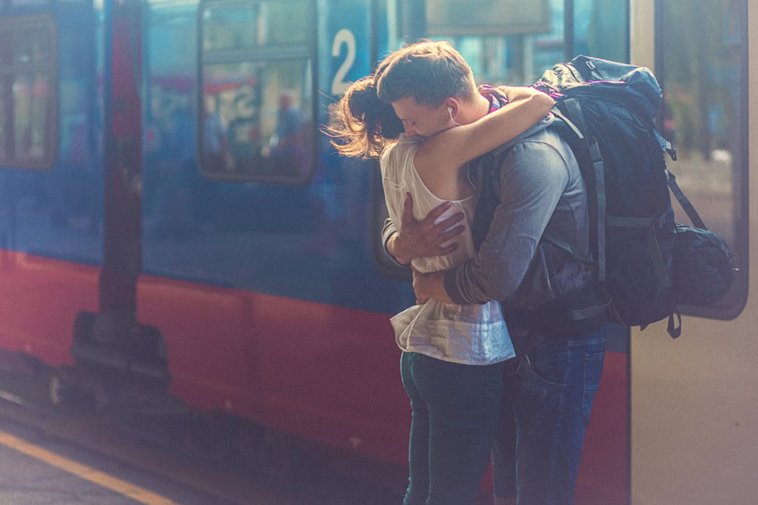 couple hugging train station departure romance