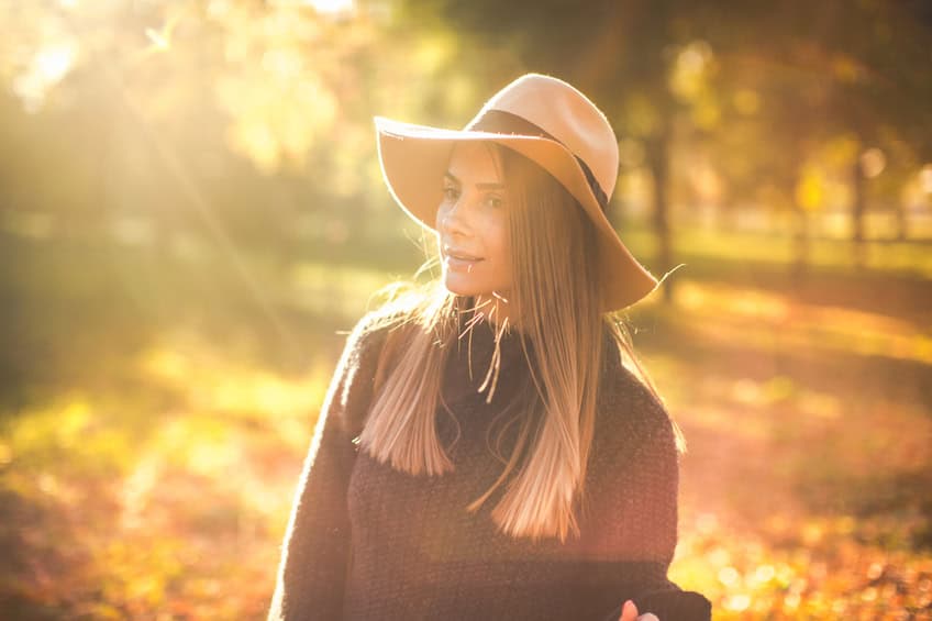 woman autumn hat park trees sun