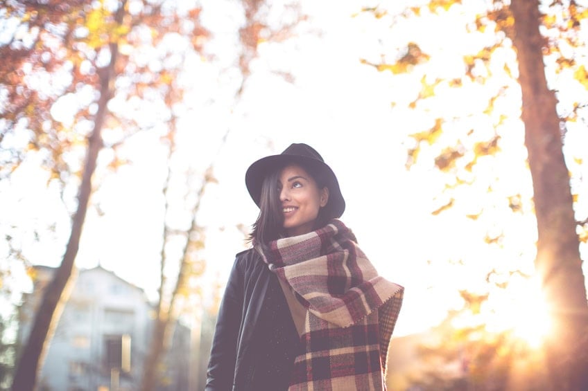 woman walking autumn hat leaves