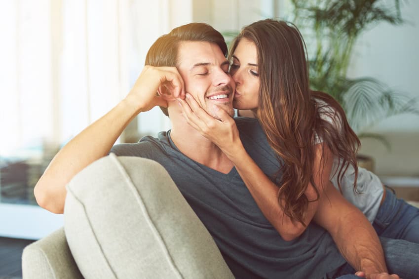 couple kiss couch home romance
