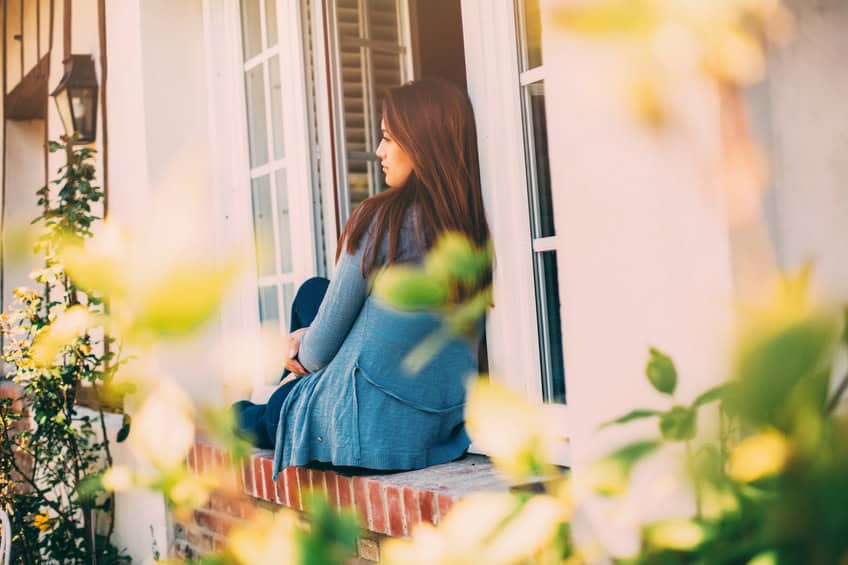 Brunette sitting window ledge