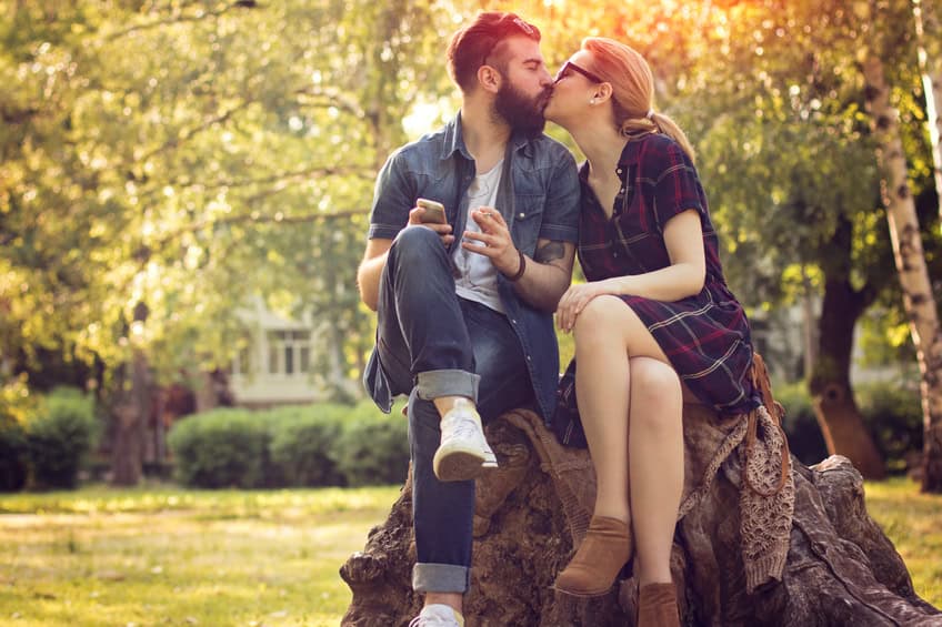 couple kissing rock summer outdoors