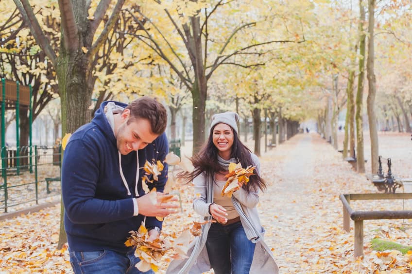 couple laughing autumn leaves happy romance
