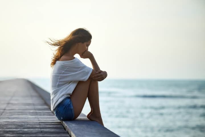 woman sad water pier outdoors