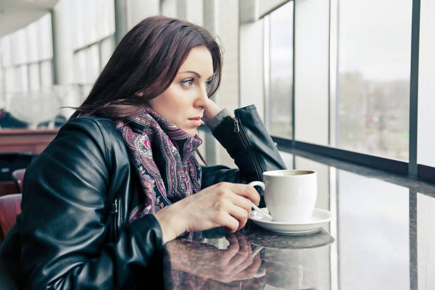 The thoughtful woman drinks coffee.