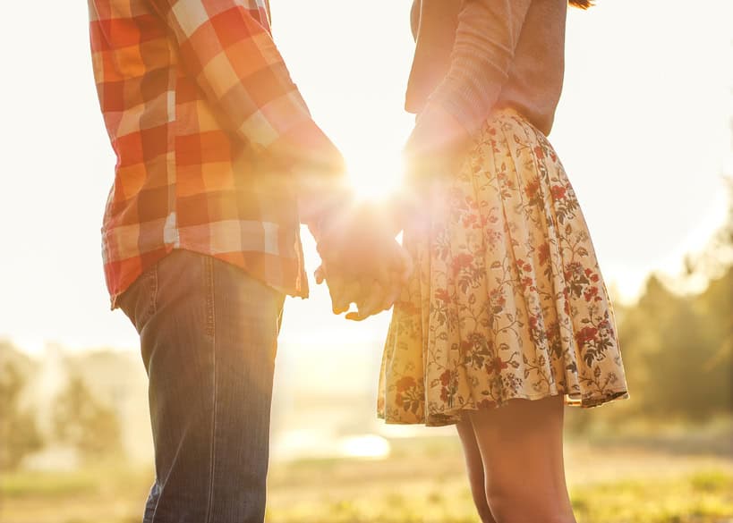 couple holding hands sunshine autumn outdoors