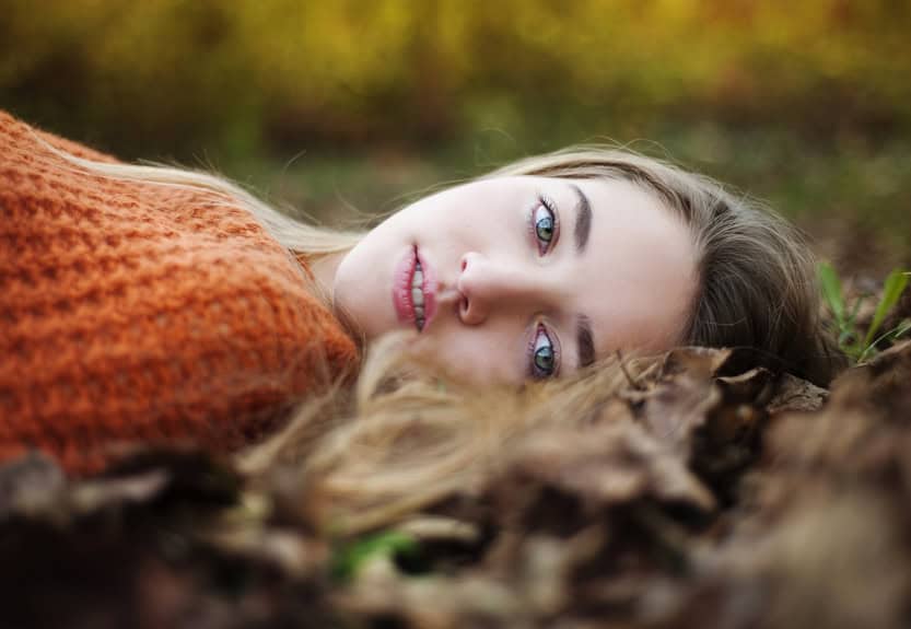 young woman forest autumn leaves