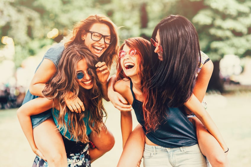 happy four women smiling